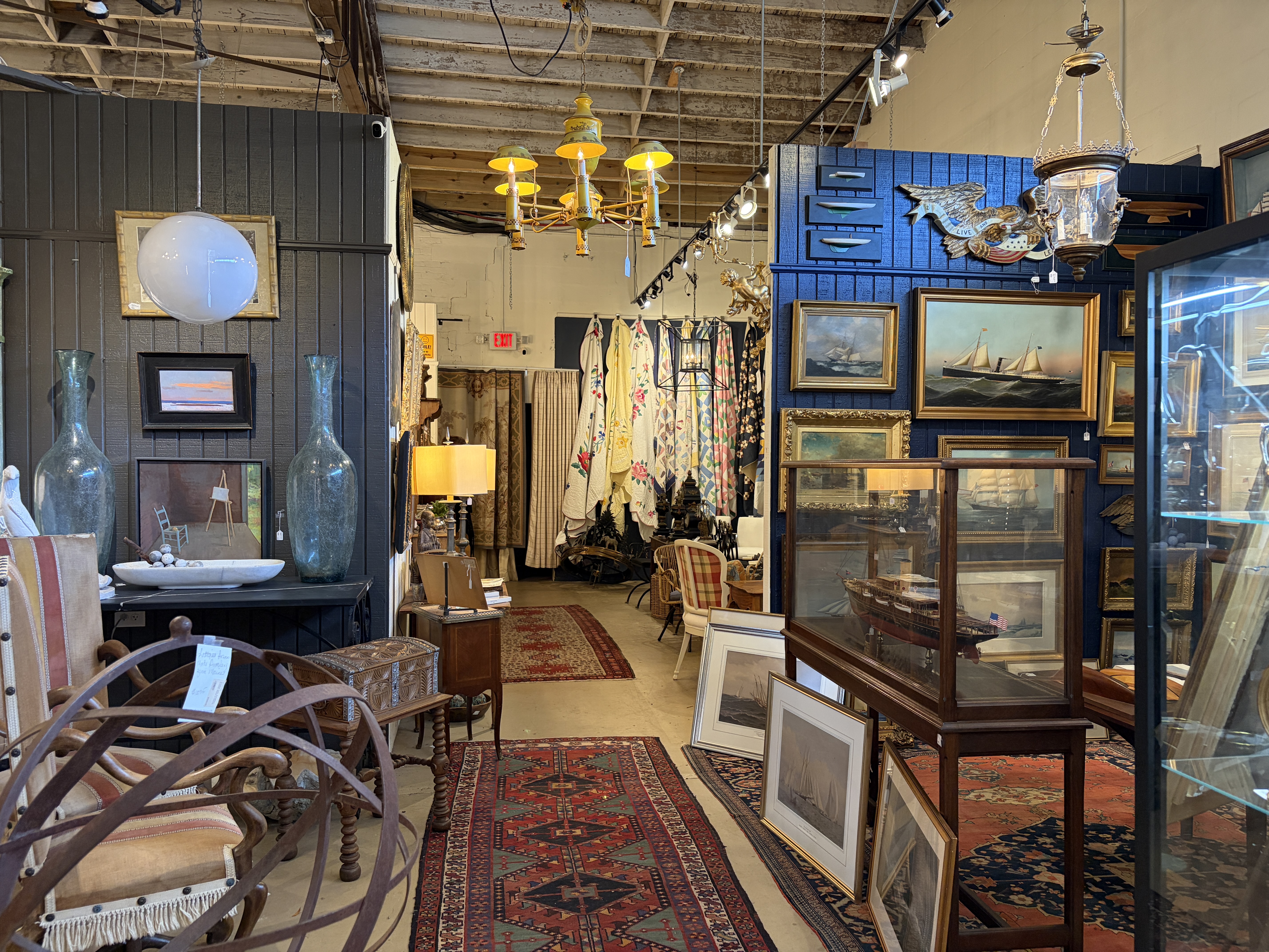 Interior photo of Wynsum antiques store in Charleston, South Carolina. Furniture, quilts, art, and accessories are available for purchase.